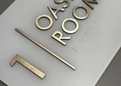 Frosted white ADA Sign with Gold Text